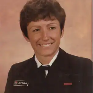 A person in a military dress uniform with a name tag reading "Battaglia" smiles against a neutral background.